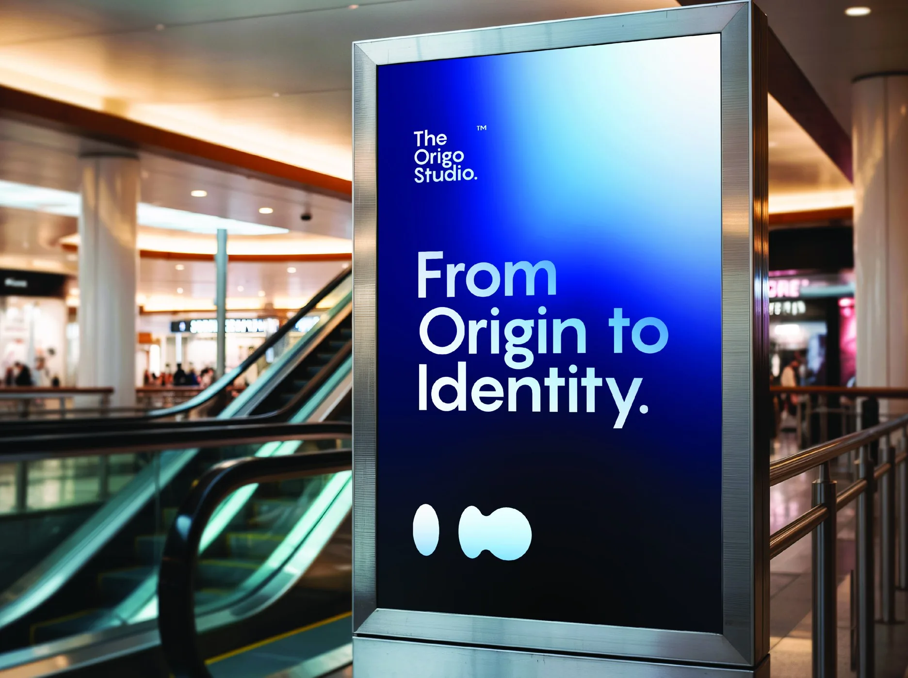 The Origo Studio poster on a mall screen: From Origin to Identity.